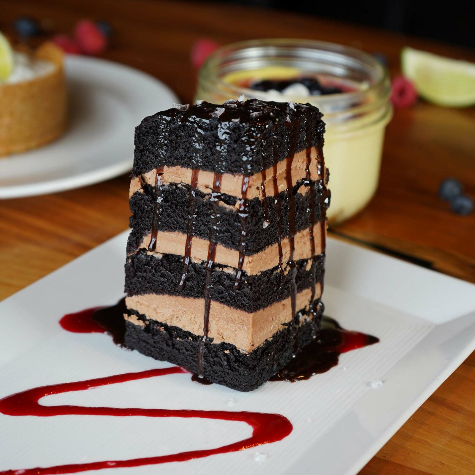 Seven layer chocolate cake with hot fudge, sea salt & raspberry coulis.