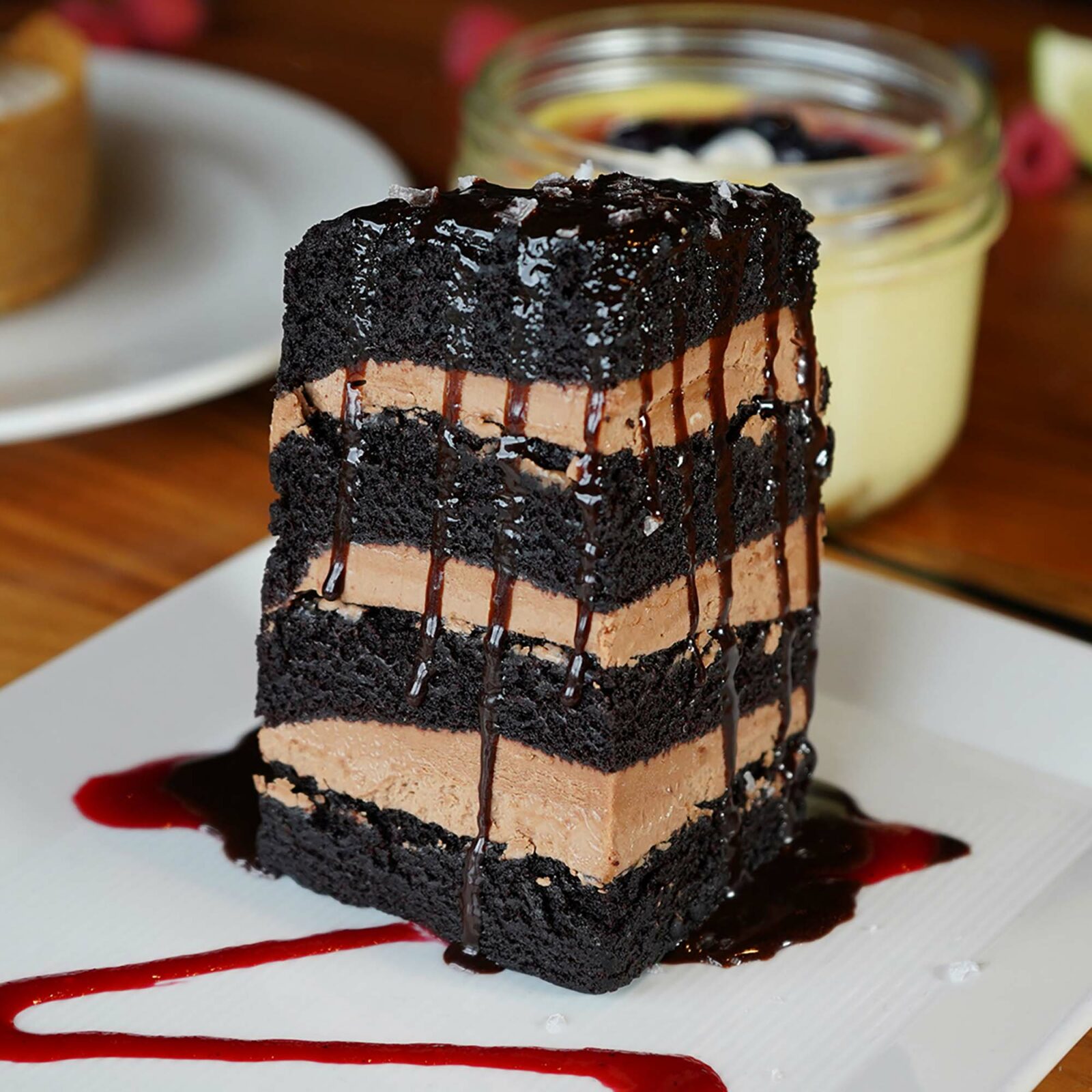 Seven layer chocolate cake with hot fudge, raspberry coulis, and maldon sea salt.
