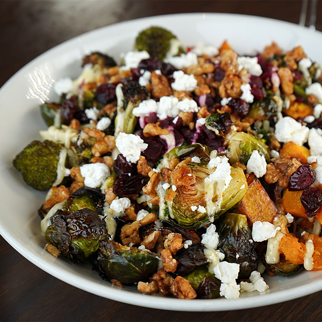 Harvest Bowl with roasted butternut squash, brussels sprouts, beets & broccoli with rice & quinoa blend, julienned vegetables, goat cheese, dried cranberries, candied walnuts, maple dijonnaise.