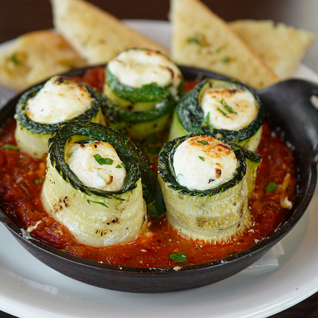 Grilled stuffed zucchini with ricotta cheese and marinara sauce at Burtons Grill & Bar.
