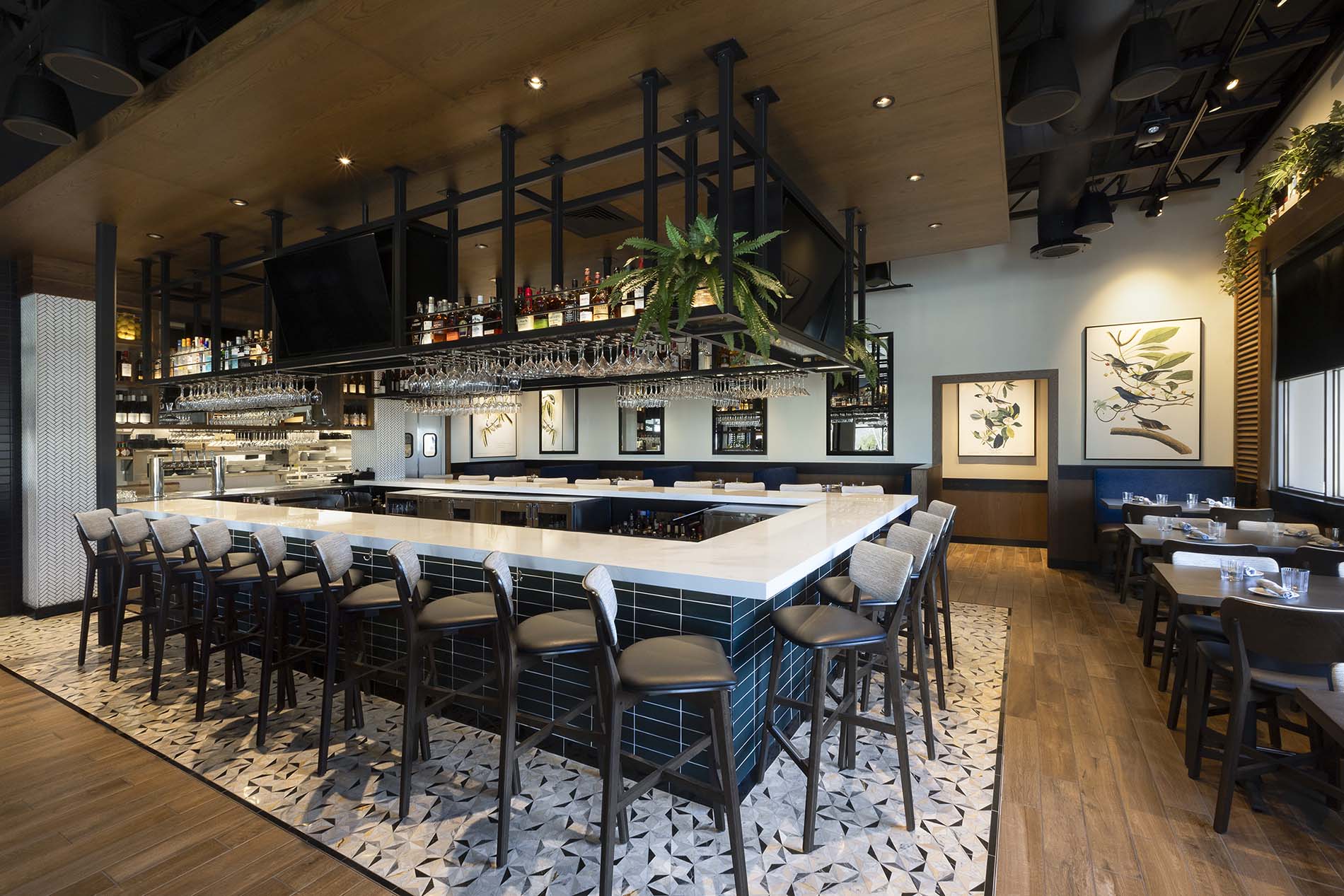 Stylish modern bar with a cozy dining area at Burtons Grill & Bar.